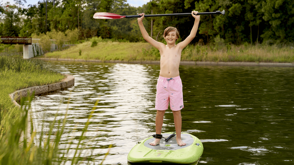 Child paddleboarding on the Woodlands river Child paddleboarding on the Woodlands river