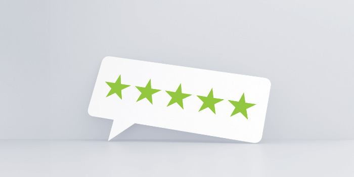 Graphics of a white text bubble with five green stars in it.